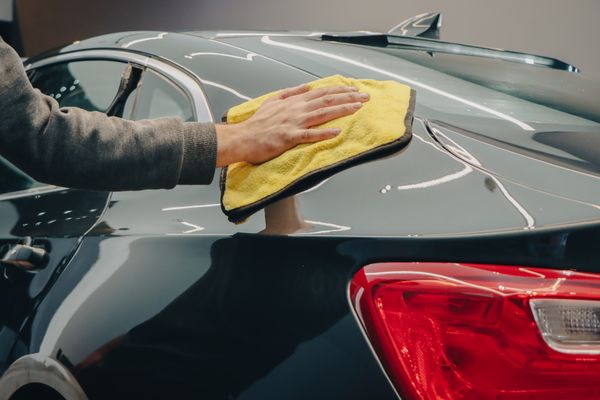 Hand polishing a car's paint to a shine
